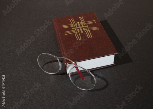 A reading pince-nez and a Christian prayer book