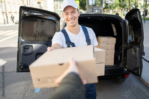 Male employee courier food delivery home. Small business service fast delivery at any time.