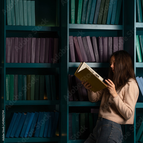 Admission to the university and preparation for exams. Natural sciences. A large amount of information. Student in the library with an open book in hands, laconic minimalistic style