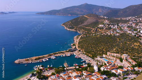 Aerial panoramic view of resort town on mountain coast. Sea bay surrounded by mountains with beautiful townscape.