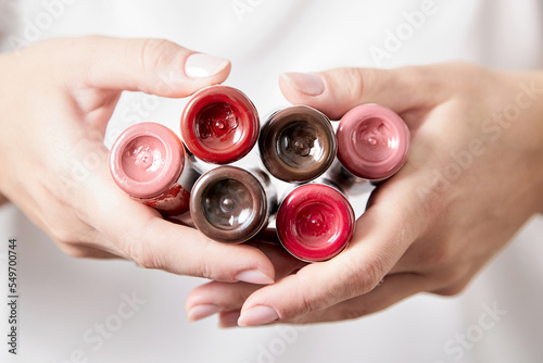 Pigments in bottles for tattoos and permanent makeup in woman hands. Tattoo ink