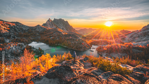 Me standing on a ledge as the sun rises over the Enchantments.