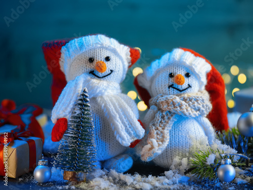 Cute pair of Christmas knitted snowmen on the festive table