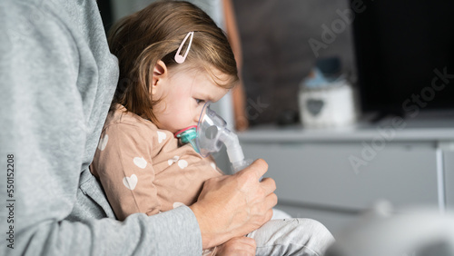 one child toddler girl using steam inhaler nebulizer at home