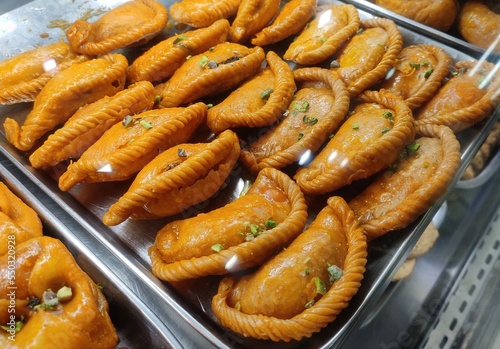 Gujia is a sweet deep-fried dumpling, native to the Indian subcontinent, made with flour stuffed with a mixture of sweetened milk solids and dried fruits and fried in ghee.