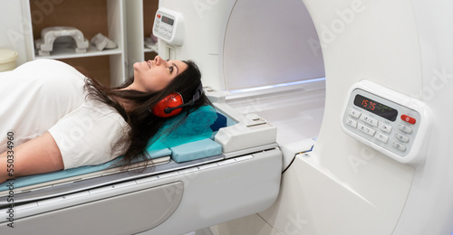 Medical CT or MRI Scan with a patient in the modern hospital laboratory. Interior of radiography department. Technologically advanced equipment in white room. Magnetic resonance diagnostics machine