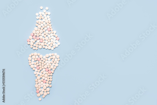 World osteoporosis day. Human joints and bone made of pills on blue background