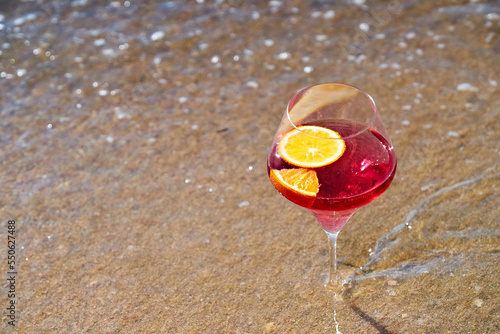 Wine glass with a cocktail by the sea.