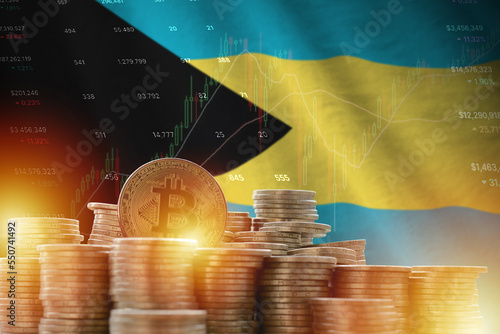 Bahamas flag and big amount of golden bitcoin coins and trading platform chart. Crypto currency concept