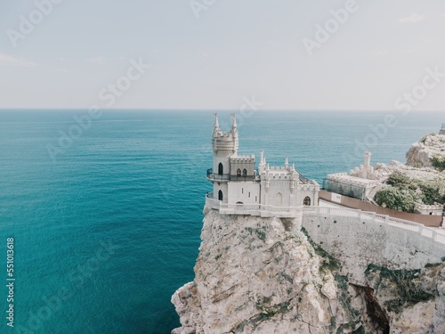 Crimea Swallow's Nest Castle on the rock over the Black Sea. It is a tourist attraction of Crimea. Amazing aerial view of the Crimea coast with the castle above abyss on sunny day.