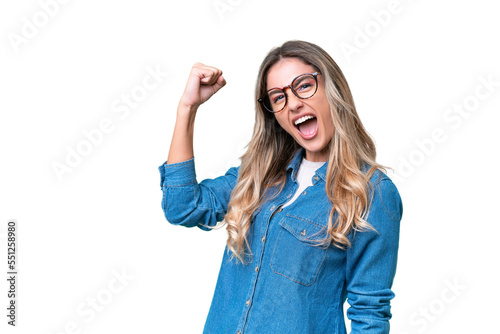 Young Uruguayan woman over isolated background celebrating a victory