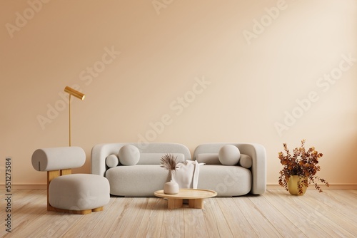 Boho style interior with gray sofa and armchair on cream color wall.