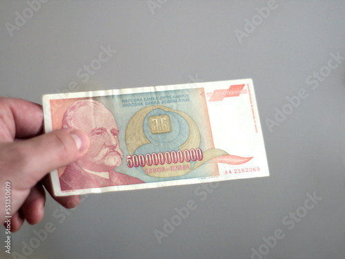 Hand of a person holding a 500000000000 - 500 billion Yugoslav dinars banknote from the period of hyperinflation in 1993