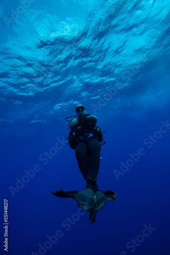 Divers waiting at the safety stop. Underwater bubbles, water bubbles. Safety stop while diving. Red Sea, Egypt.