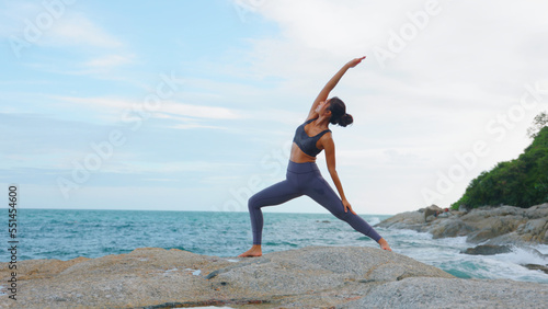 Asian woman improves balance for body, mind and spirit with yoga