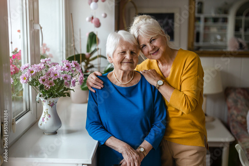 Woman hugging her elderly mother 