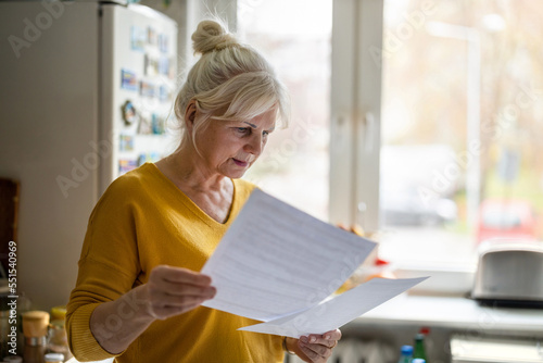 Senior woman filling out financial statements 