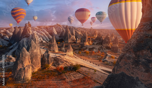 Group horse riding tour with hot air balloons in Cappadocia autumn landscape Turkey top aerial view