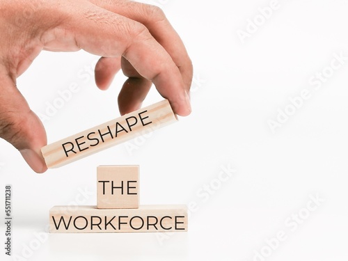 Phrase reshape the workforce on wooden cubes with hand.