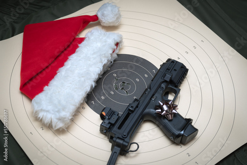 Christmas shooting. A pistol with a collimator sight and butt, a gnome's hat and a target for shooting.