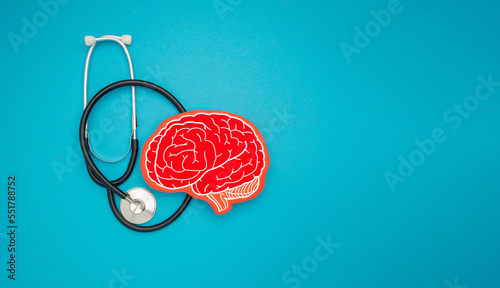 A brain shape symbol and a stethoscope on a blue background