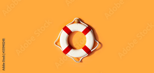Lifebuoy on orange background. Copy space