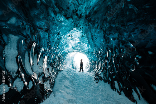 Person is standing in beautiful ice cave in Vatnajkull glacier Iceland in the winter