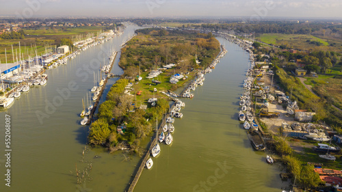 Aerial view on the Holy Isle located in Fiumicino, Italy. It' s an artificial island on the Tiber River, near Rome. Many boats are anchored.