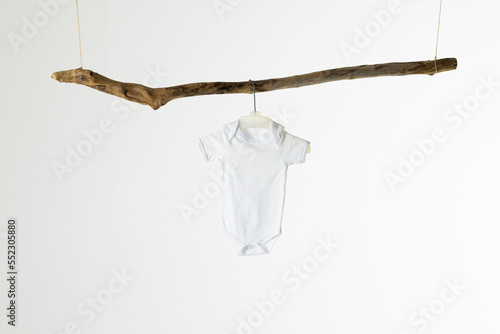 White baby cloth hanging and copy space on white background