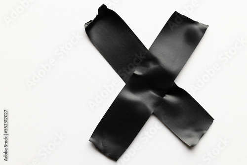 Cross shape black masking tape on white background