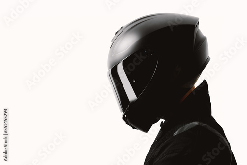 Portrait of a motorcycle rider posing with a black helmet on a white background.