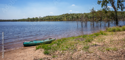 A kayak on the edge of the calm waters of Lake Boondooma or Boondooma Dam on the Boyne River near Proston in the South Burnett Region, Queensland, Australia.