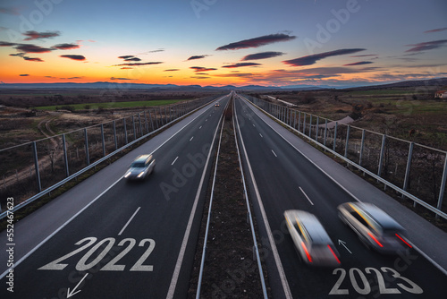 Driving on open road at beautiful sunny day to new year 2023. Aerial view of travel and transportation on highway. 
