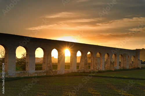 Sunset at the Gozo Aqueduct, an aqueduct on the island of Gozo, Malta. It was built by the British between 1839 and 1843 to transport water from Għar Ilma ito Victoria