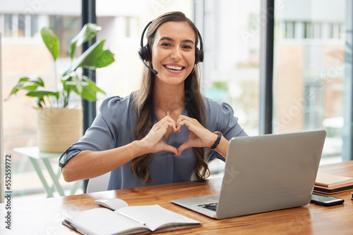 Woman, call center and laptop with heart gesture for telemarketing, customer service or support at the office. Portrait of happy employee consultant with smile and hands with love symbol by computer