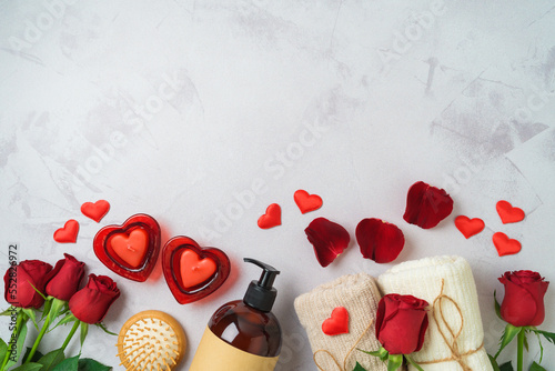 Valentines day and romantic spa treatment concept. Towels, rose flowers and candles on bright background. Top view, flat lay