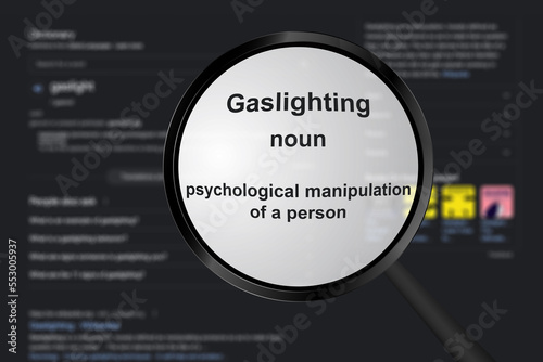 Gaslighting, word in a dictionary. magnifier showing meaning of the word gaslighting