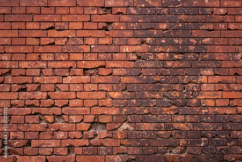 Red brick wall with holes from shots in the Brest Fortress.