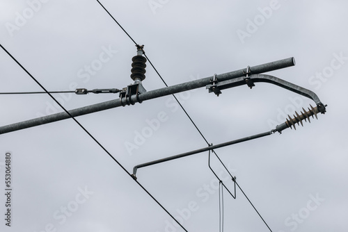 Electric train catenary against coudy sky