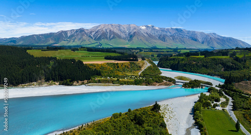 Aerial view with road of highway as bridge at Rakaia River lagoon Valley as green field againts with blue sky background