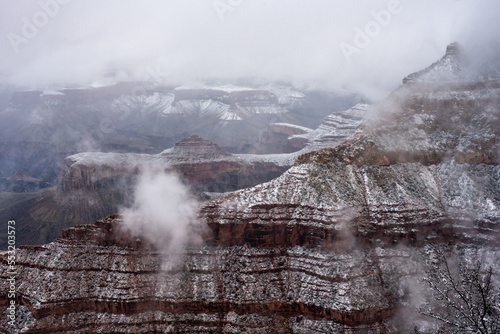 Thin Clouds Hang Over Snow Covered Ridges of Grand Canyon