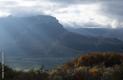 Forests with autumn colors in the Aralar mountain range and San Donato mountain in the background, Navarra, Spain.