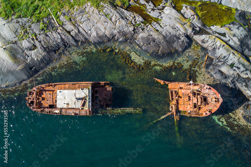 Stranded transport ship destroyed on the cliffs of a remote island after an accident