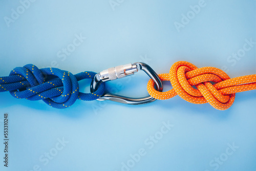 Grey carbine with clutch. Equipment for climbing and mountaineering. Safety rope. Knot eight