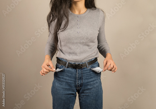 Young woman showing empty pocket