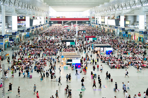 Large group of people waiting at train station hall