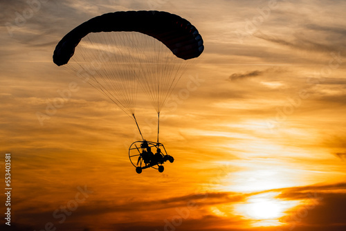 Powered paraglider in sunset