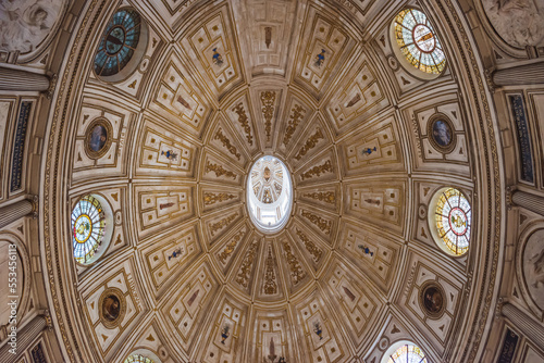 Elliptical shaped dome ceiling with stained glass windows and paintings in the Chapter House inside the Cathedral of Seville SPAIN