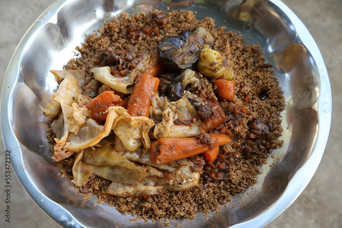 Thieboudienne or chebu jen: traditional national dish of Senegalese cuisine. Plate with thieboudienne with seafood in cafe in Senegal, Africa. African food, cuisine. Spicy Senegalese tiep or thieb