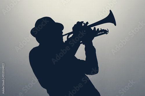 silhouette of a jazz man playing trumpet